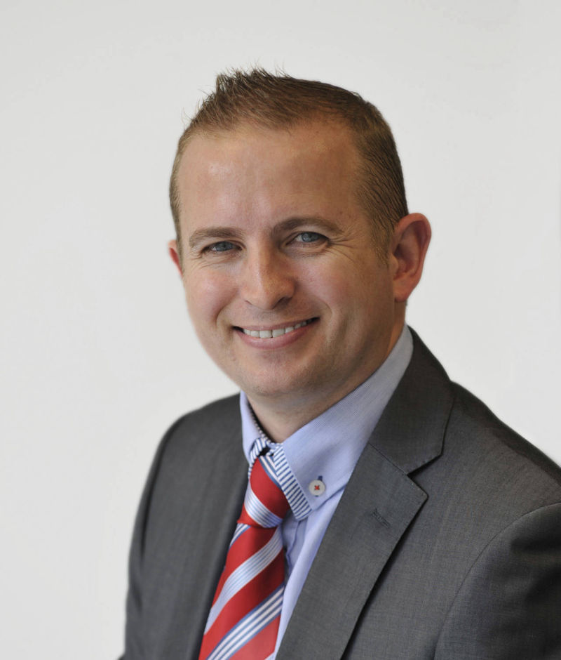 studio headshot of corporate executive in office