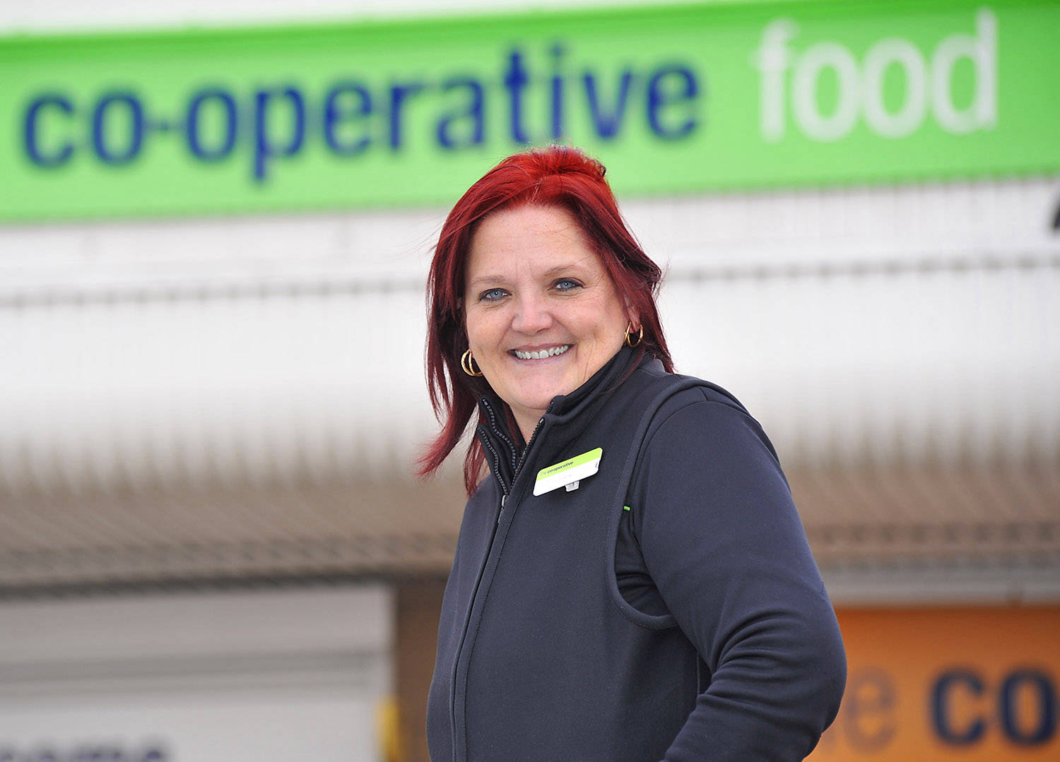 co op staff headshot outside supermarket photo taken for magazine.