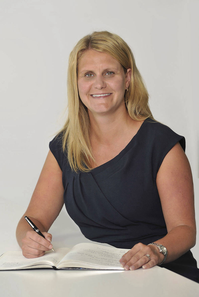 portrait of woman account executive at desk in office image produced for press release, by  picturepress photography birmingham.