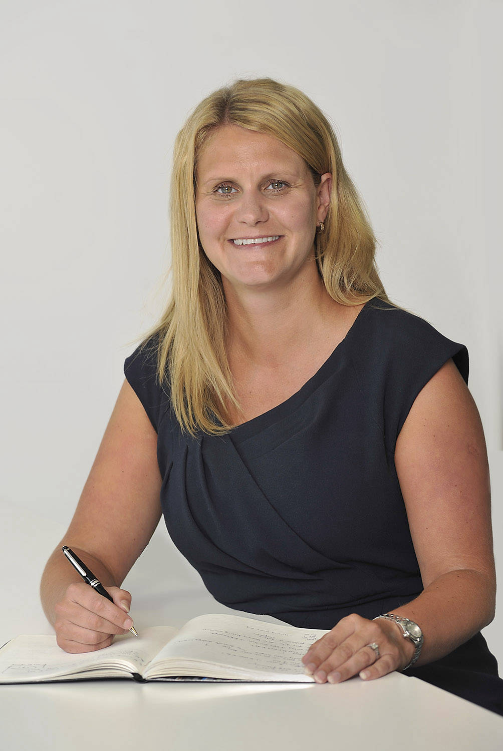 portrait of woman account executive at desk in office image produced for press release, by  picturepress photography birmingham.