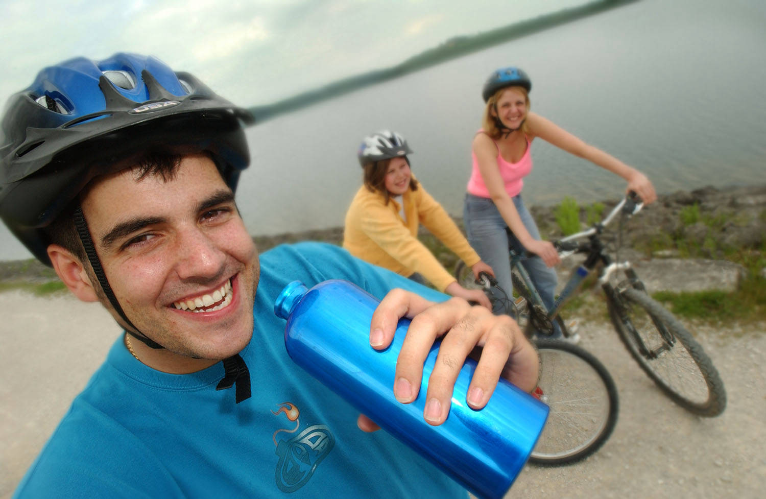 cyclist holding waterbottle. by lake.  image produced for poster and annual report and accounts for severn trent water by picturepress  photography