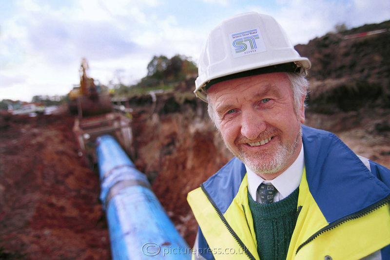 headshot of severn trent water engineeron site with water pipes in background photo taken for  taken for annual report by photographer mike kelly picturepress. birmingham